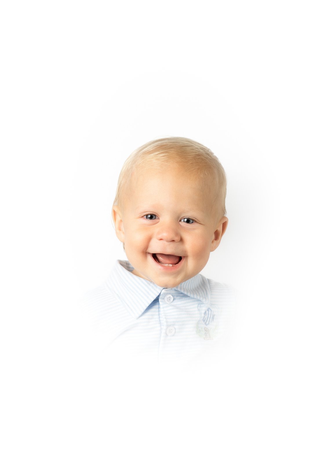 Heirloom portrait — a smiling toddler in a soft blue collar