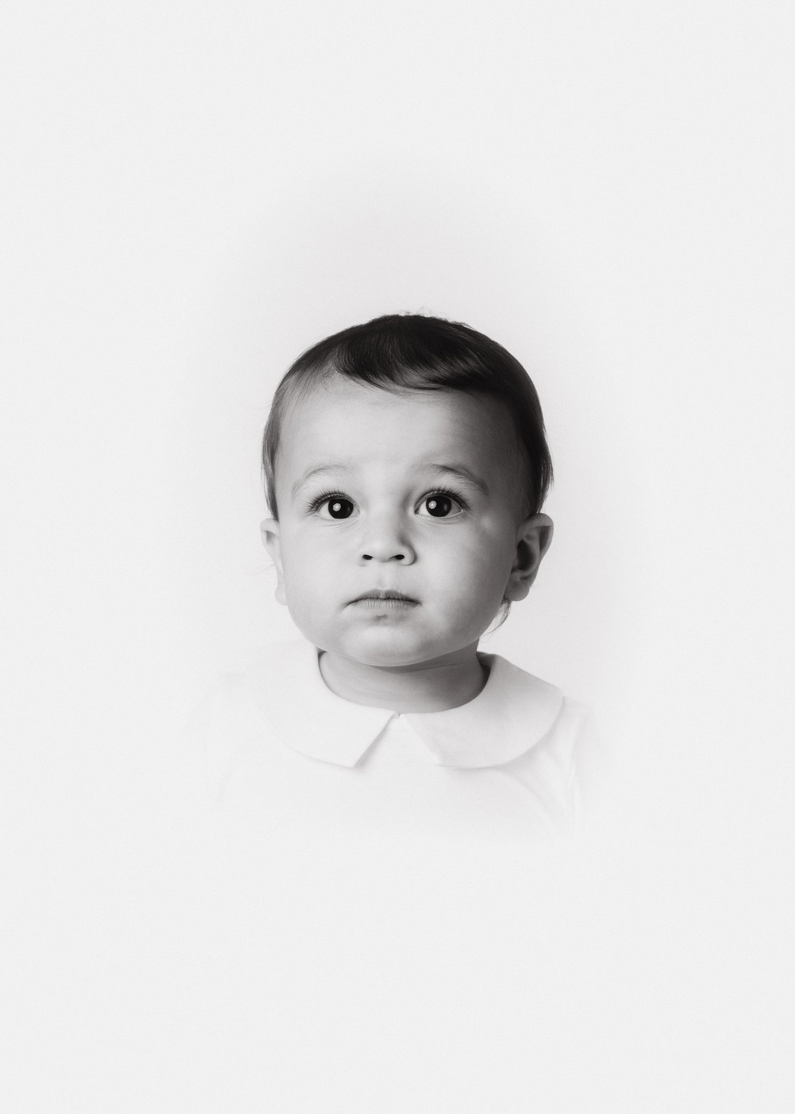 Heirloom portrait — a contemplative toddler in black and white